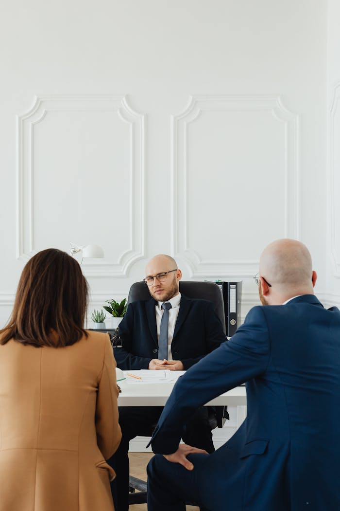 Mastering the First Impression: Your intriguing post title goes here A lawyer consults a couple on divorce proceedings in an elegant office setting.