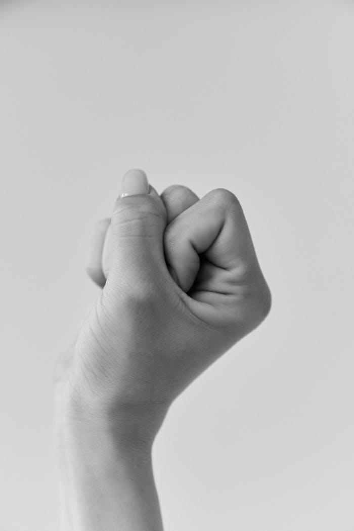 about-img A powerful black and white image of a clenched fist representing strength and determination.